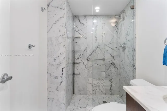 a bathroom with a shower toilet and sink