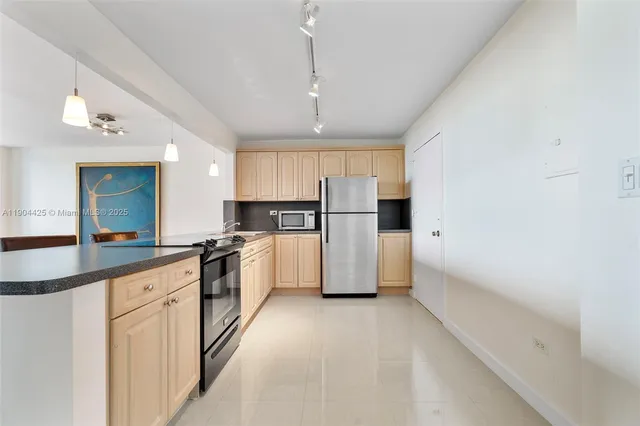 a kitchen with refrigerator and cabinets