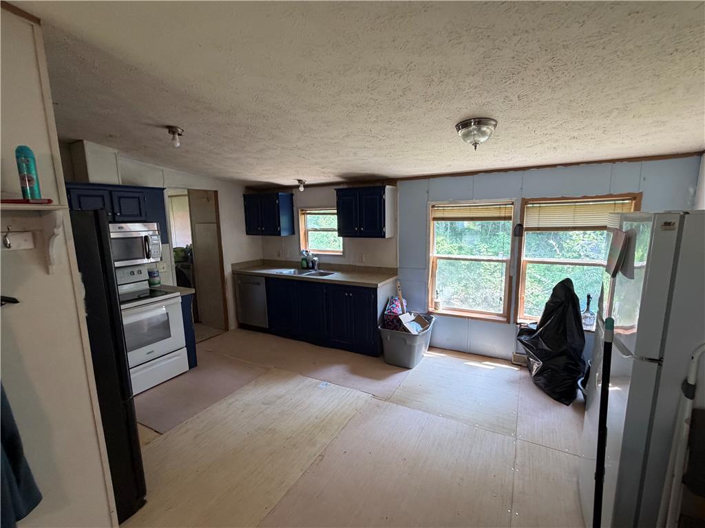 4541 Main Street Slatington, PA 18080 - Photo 22 of 27 A functional kitchen space awaits customization, offering ample natural light from two large windows.