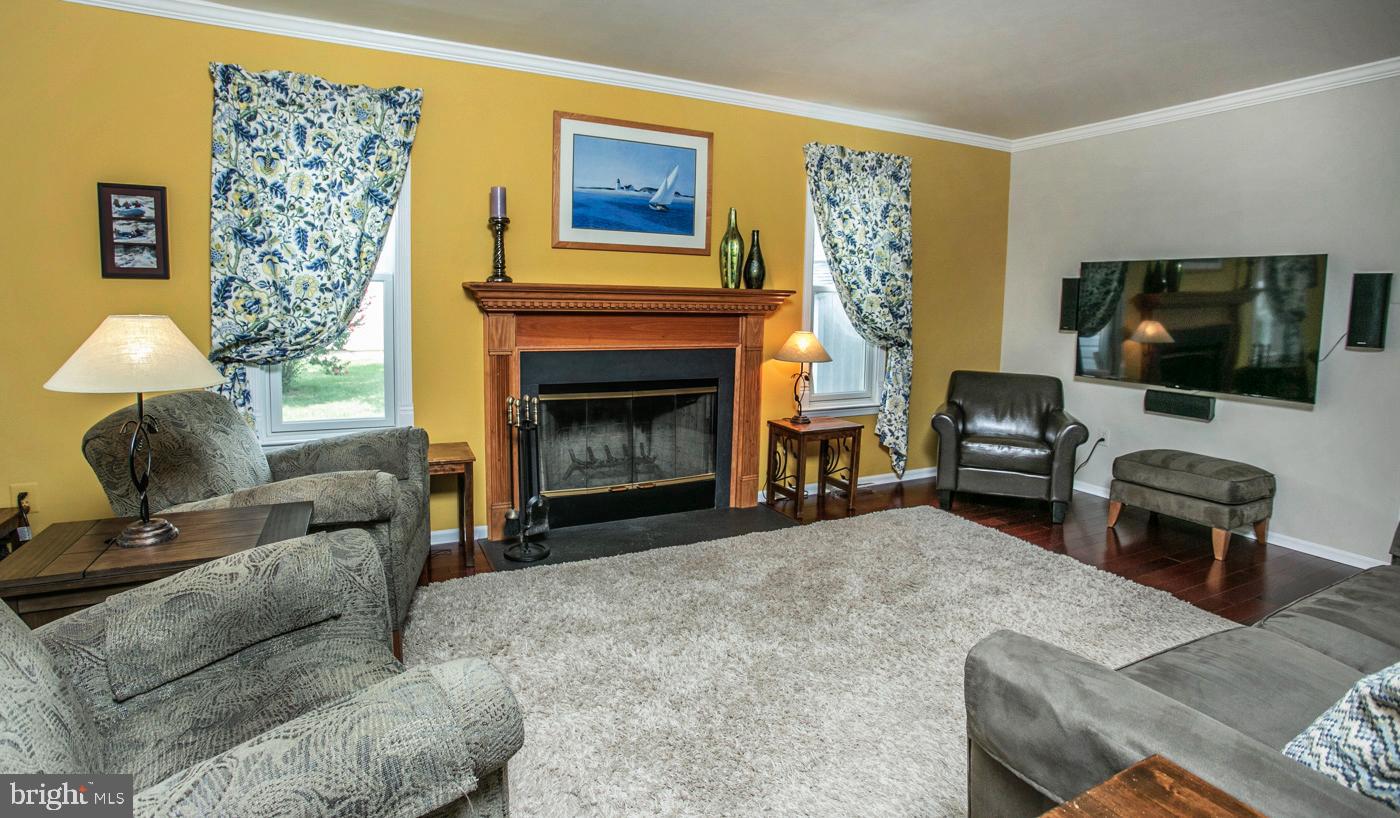 116 Summer Ridge Drive Lansdale, PA 19446 - Photo 22 of 52 a living room with furniture a flat screen tv and a fireplace