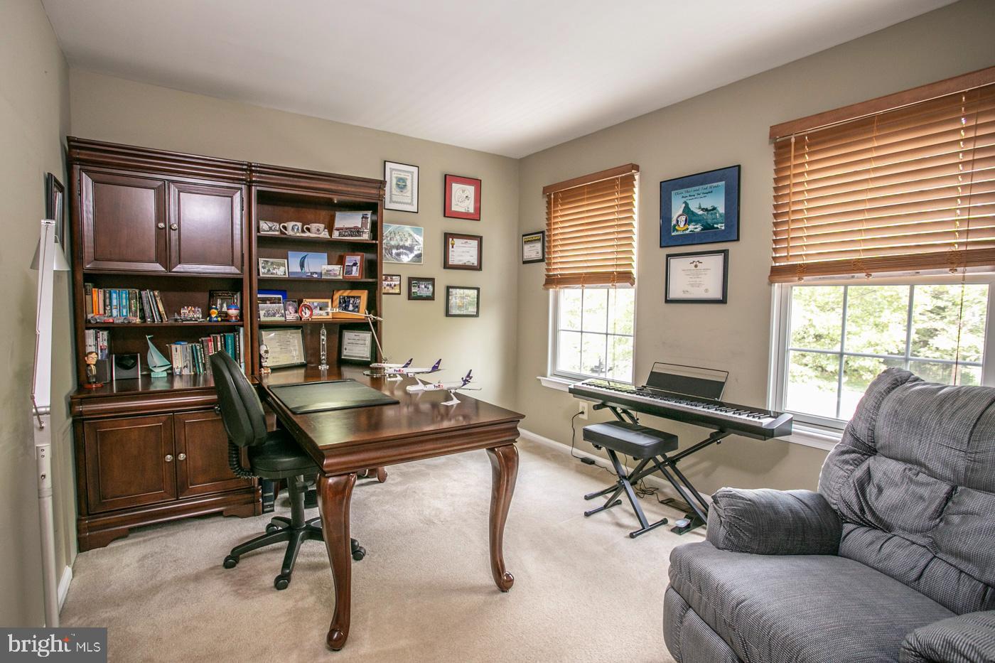 116 Summer Ridge Drive Lansdale, PA 19446 - Photo 36 of 52 a living room with furniture a bookshelf and a window
