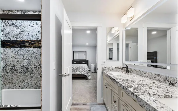 a bedroom with a bed and a lamp