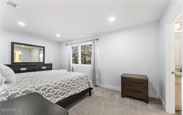 a bedroom with a bed and window