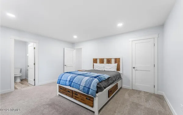 a bathroom with a granite countertop sink a toilet and shower