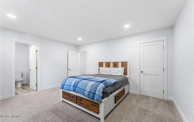 a bathroom with a granite countertop sink a toilet and shower