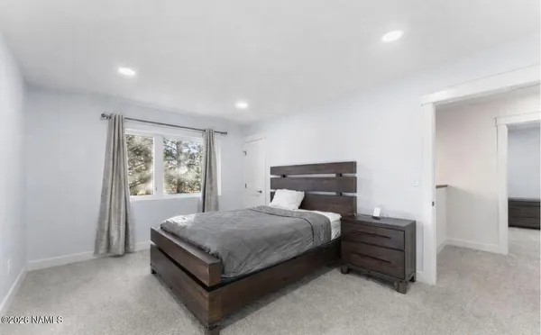 a bathroom with a granite countertop toilet sink and mirror