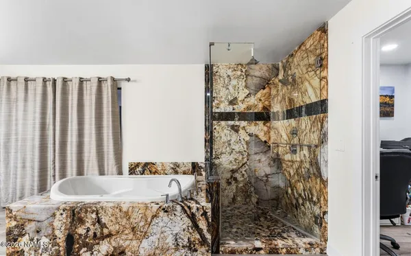 a spacious bathroom with a double vanity sink a mirror and a