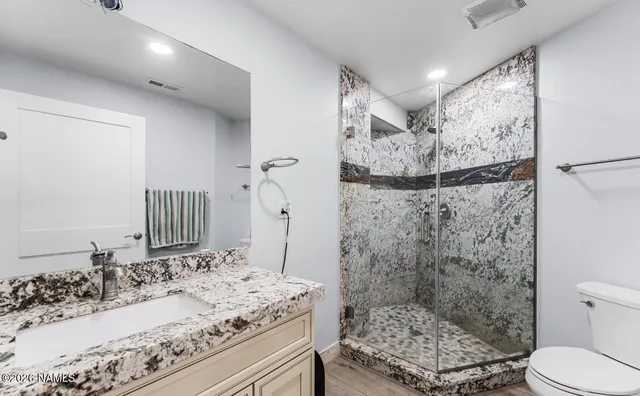 a view of a house with a wooden deck