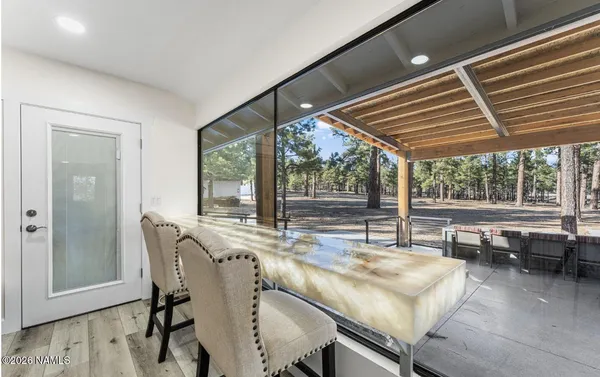 a dining room with furniture and a window