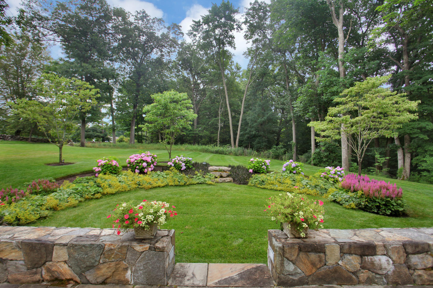 538 Laurel Road New Canaan, CT 06840 - Photo 16 of 28 a garden with flowers and trees
