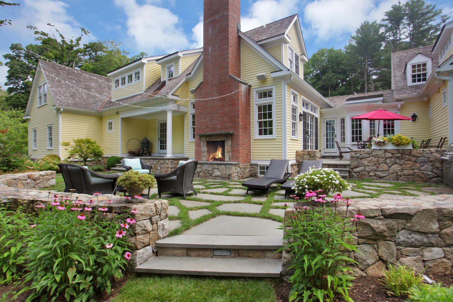 538 Laurel Road New Canaan, CT 06840 - Photo 17 of 28 a front view of a house with a garden