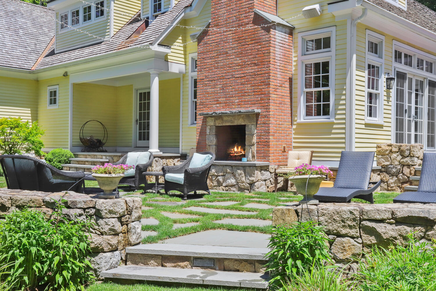 538 Laurel Road New Canaan, CT 06840 - Photo 21 of 28 a front view of a house with garden and sitting area
