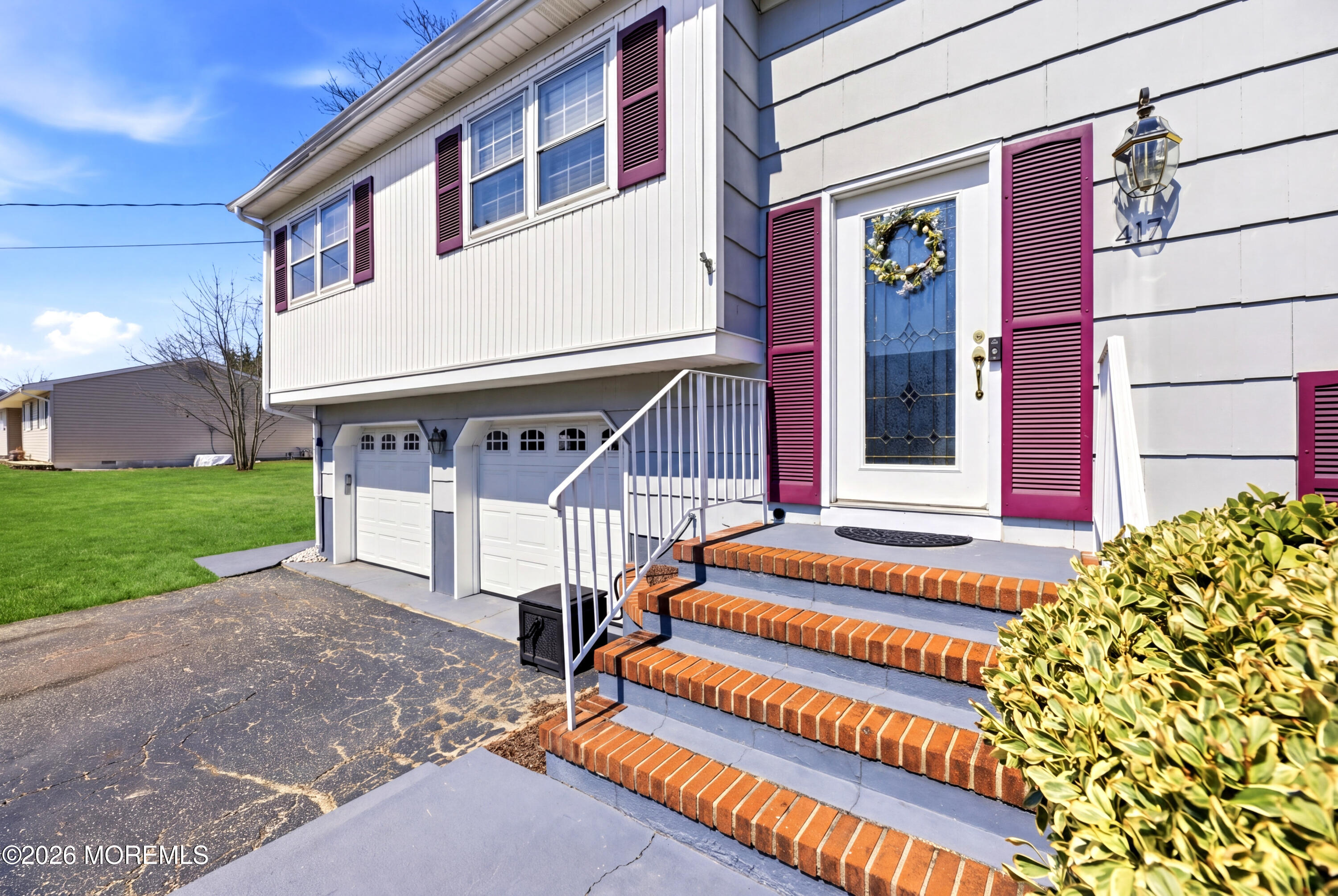 417 Crestview Terrace Brick, NJ 08723 - Photo 3 of 35 a front view of a house with a yard
