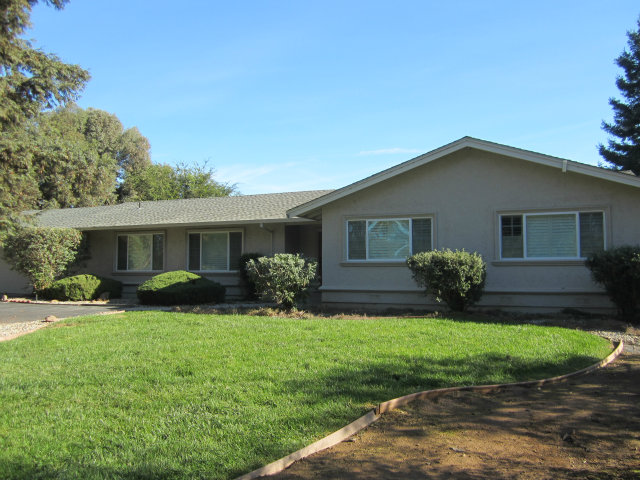 a front view of house with yard and green space