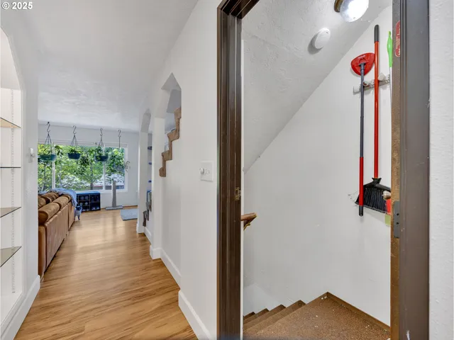 a view of a hallway and a livingroom with furniture