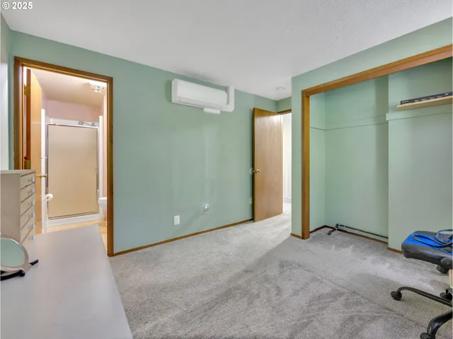 an empty room with closet and mirror