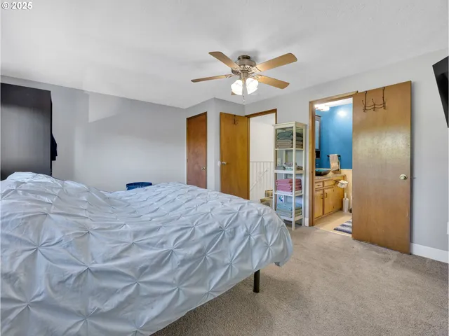 a spacious bedroom with a bed and a large mirror