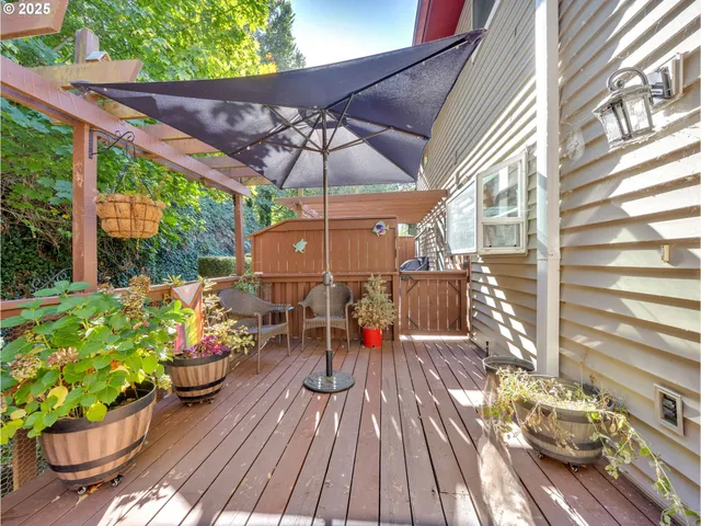 a view of a patio with table and chairs under an umbrella