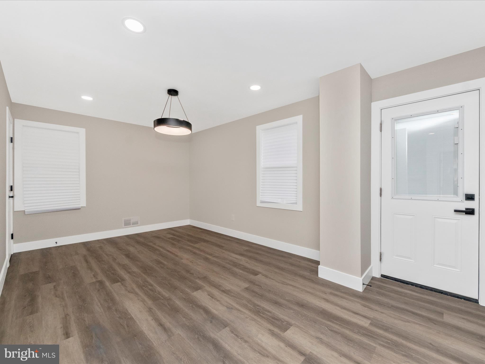2812 Manoff Road Halethorpe, MD 21227 - Photo 11 of 55 an empty room with wooden floor and windows