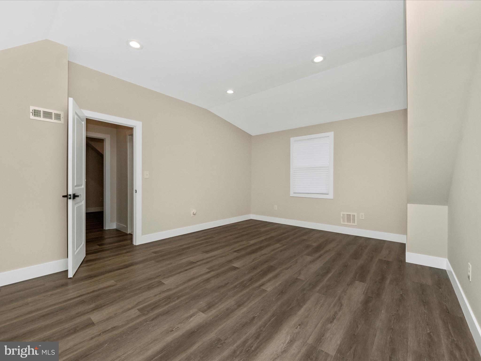 2812 Manoff Road Halethorpe, MD 21227 - Photo 15 of 55 a view of an empty room with wooden floor and a window