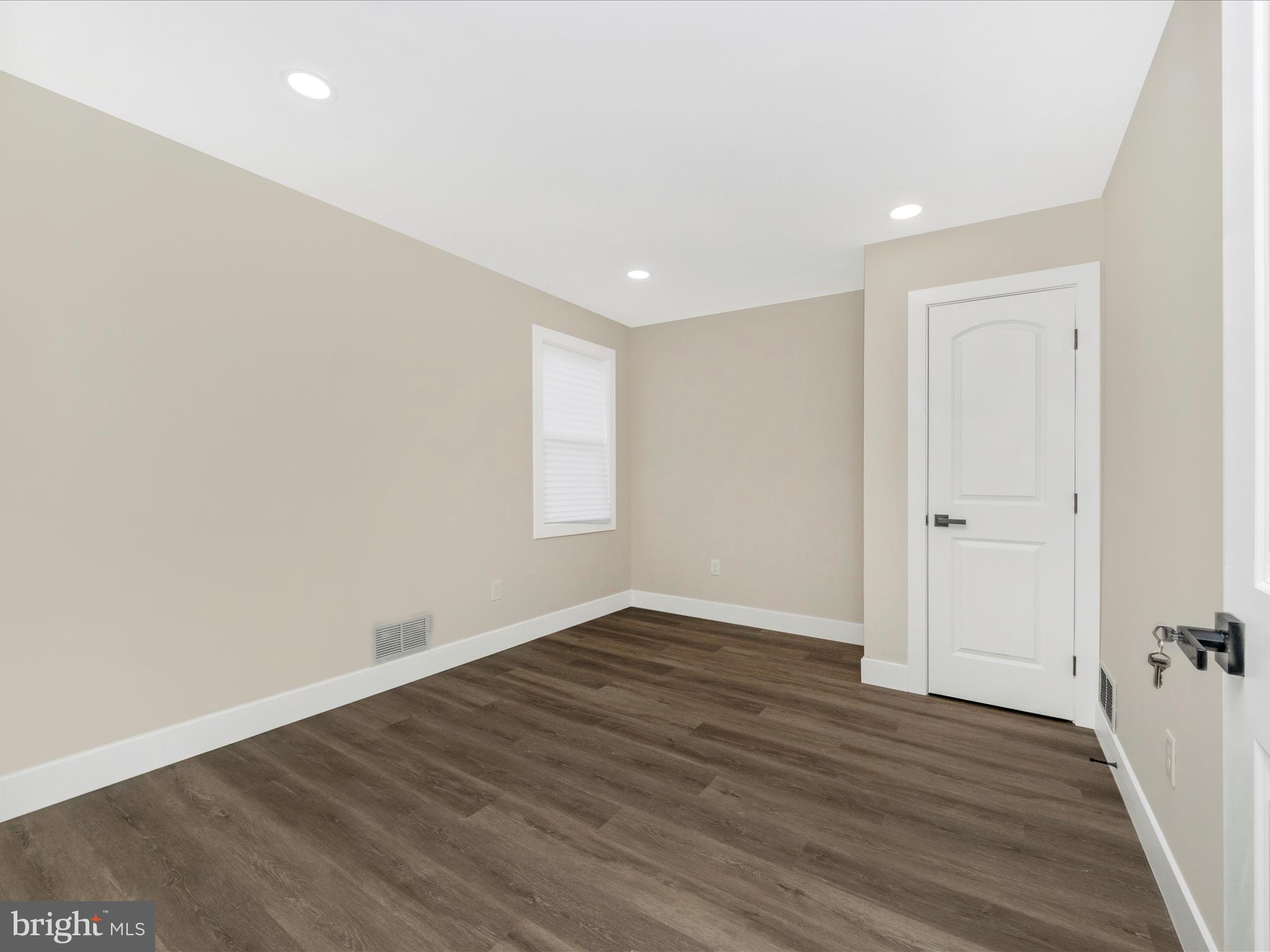 2812 Manoff Road Halethorpe, MD 21227 - Photo 18 of 55 wooden floor in an empty room with a window