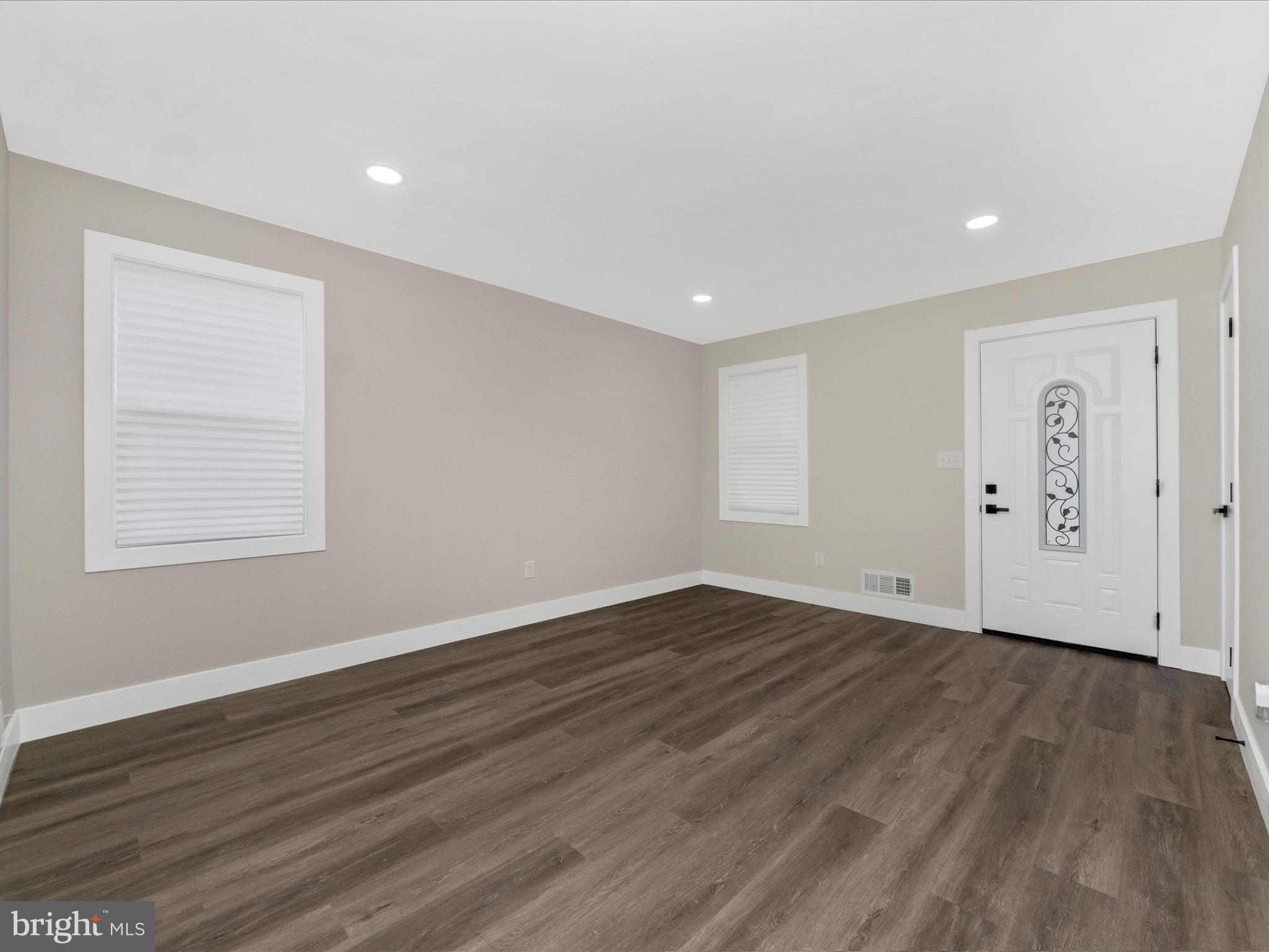 2812 Manoff Road Halethorpe, MD 21227 - Photo 6 of 55 a view of an empty room with wooden floor and a window