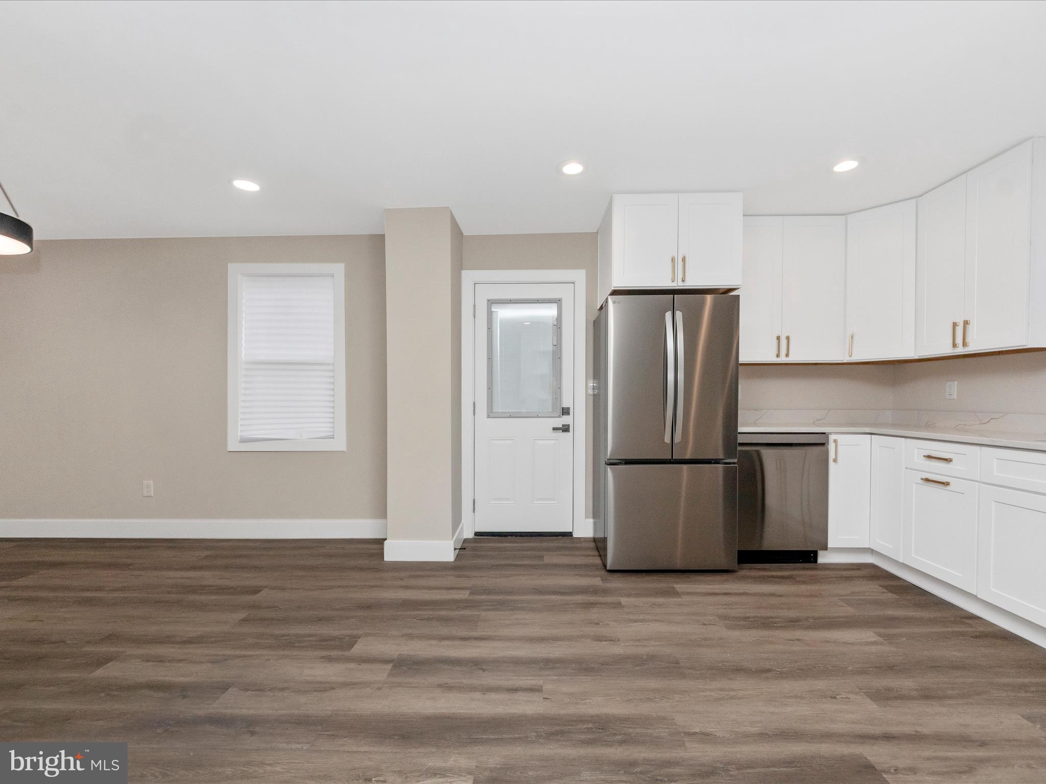 2812 Manoff Road Halethorpe, MD 21227 - Photo 7 of 55 a kitchen with stainless steel appliances granite countertop a refrigerator sink and cabinets