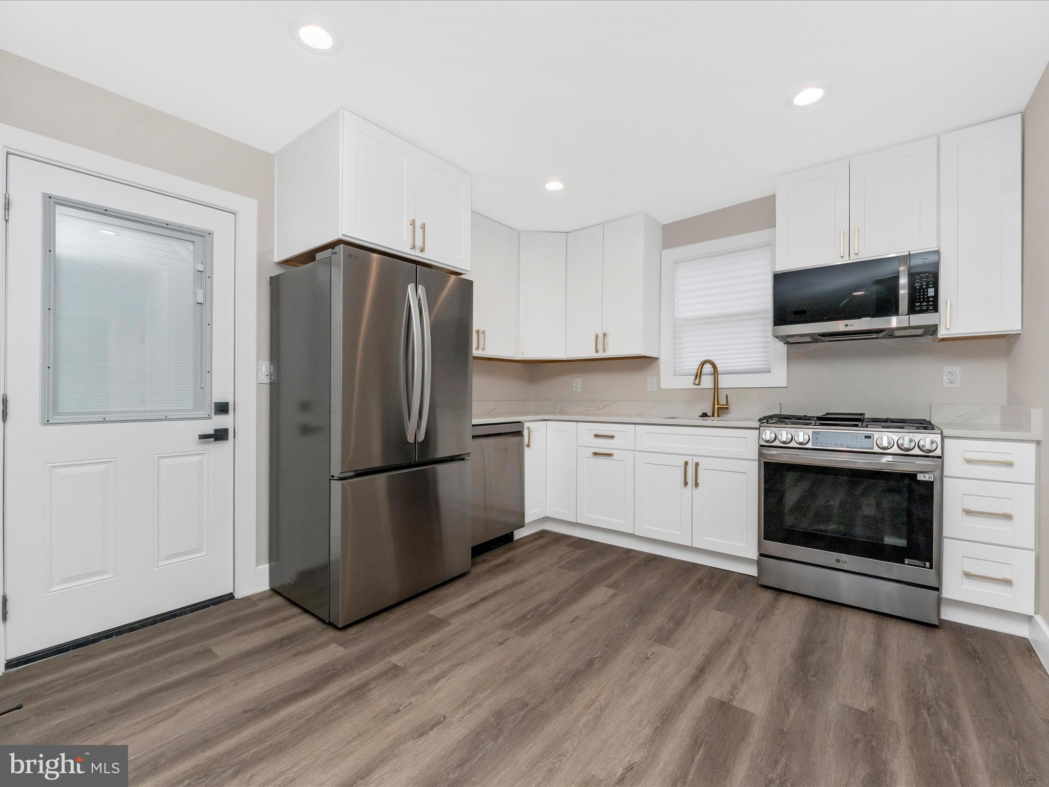 2812 Manoff Road Halethorpe, MD 21227 - Photo 8 of 55 a kitchen with a refrigerator and a stove top oven