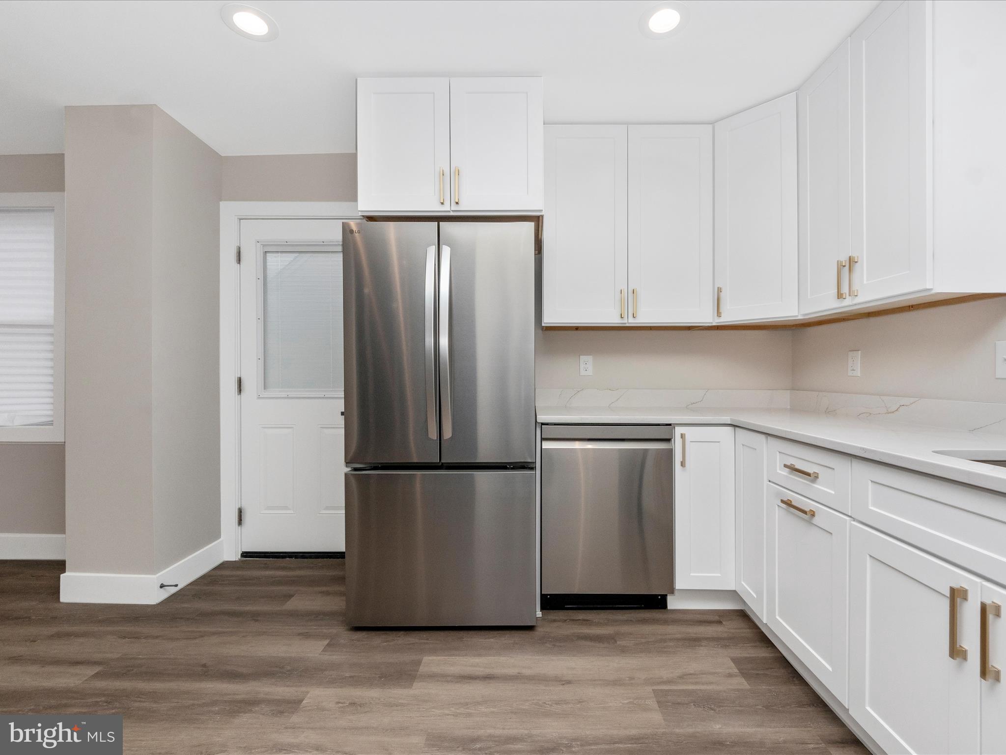 2812 Manoff Road Halethorpe, MD 21227 - Photo 9 of 55 a kitchen with wooden cabinets and stainless steel appliances
