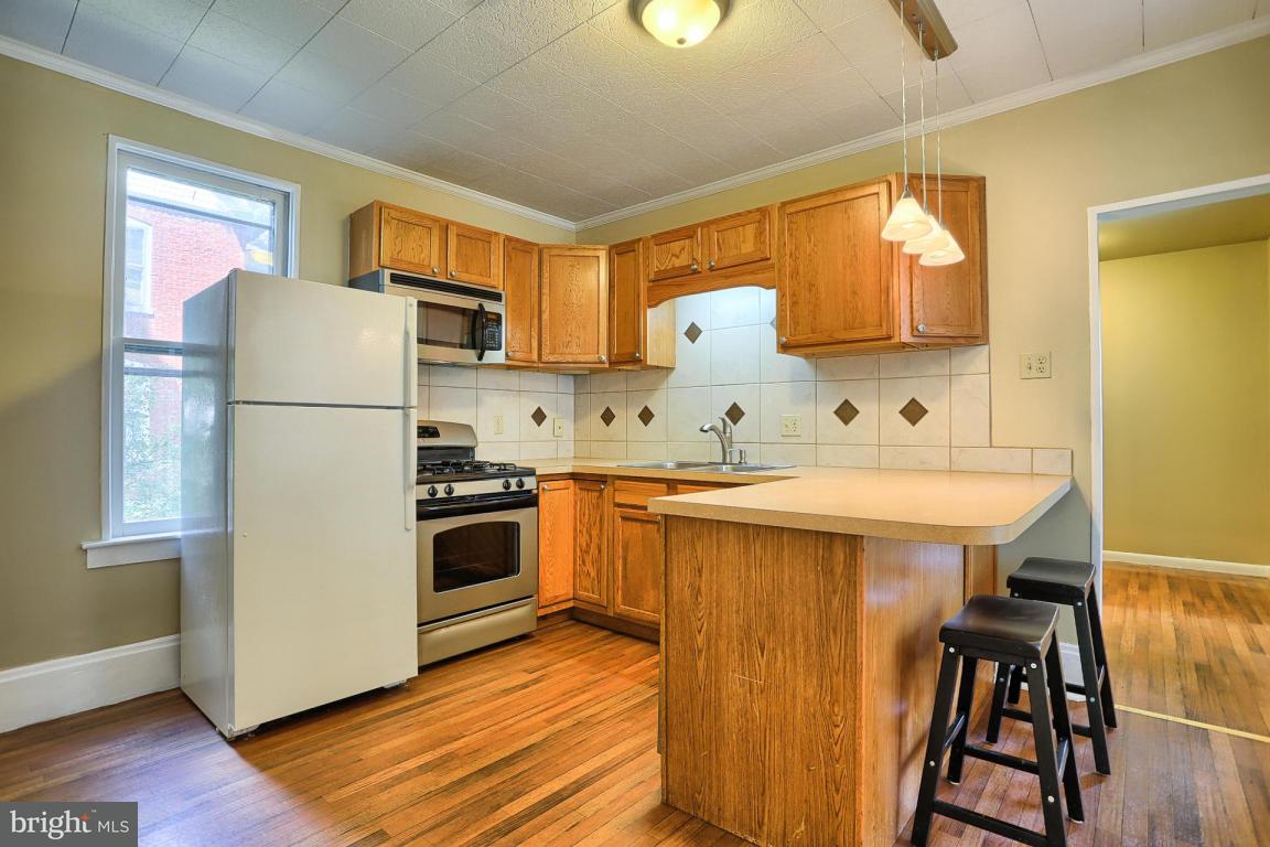 149 Front Street Lititz, PA 17543 - Photo 21 of 33 a kitchen with a sink a refrigerator and wooden floor