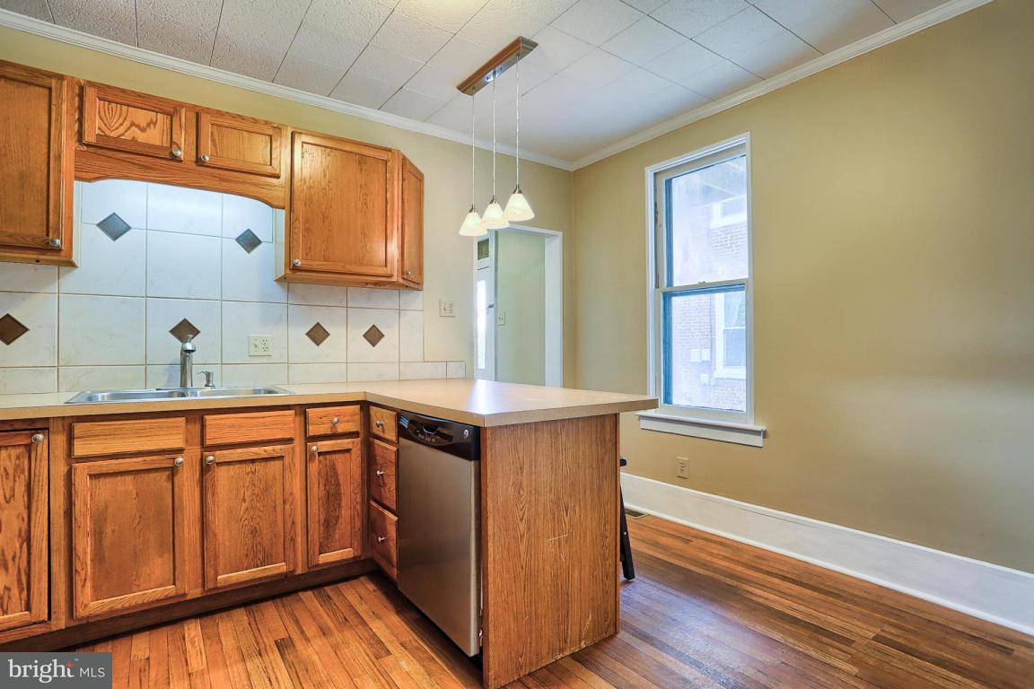 149 Front Street Lititz, PA 17543 - Photo 22 of 33 a kitchen with stainless steel appliances granite countertop a sink a stove cabinets and wooden floor