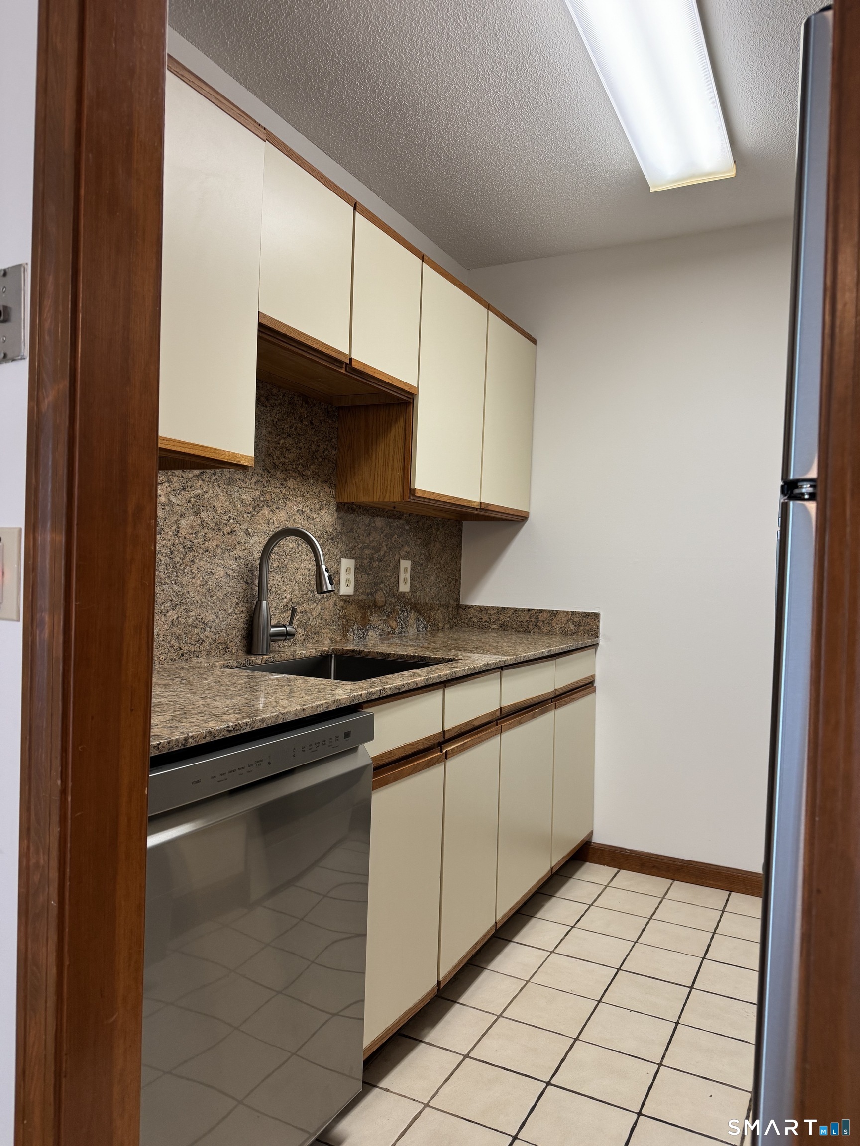 1022 Main Street, Unit 7 Branford, CT 06405 - Photo 5 of 10 a kitchen with granite countertop a sink and a stove