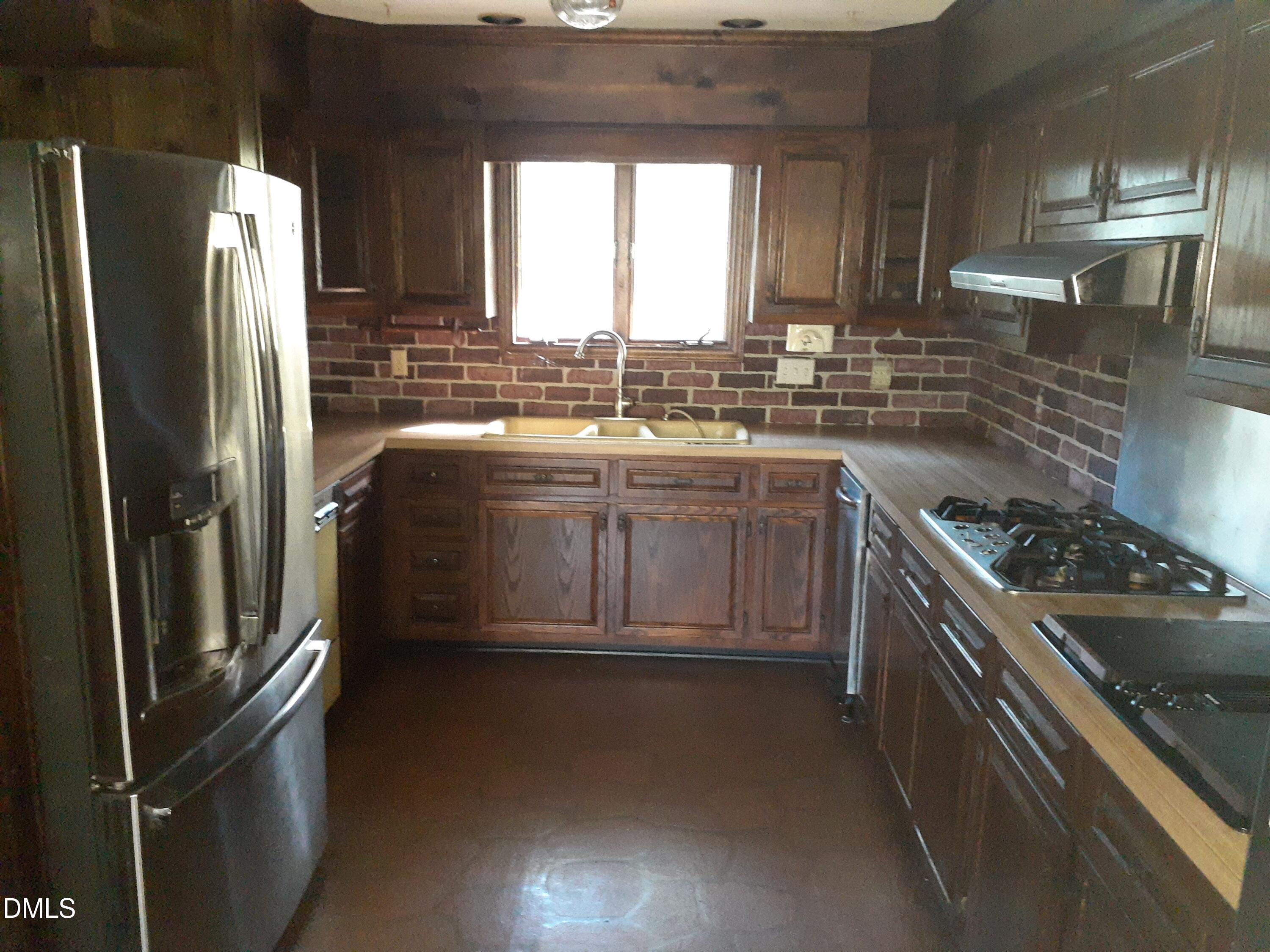 1576 Munns Road Creedmoor, NC 27522 - Photo 13 of 25 a kitchen with stainless steel appliances granite countertop a sink stove and refrigerator