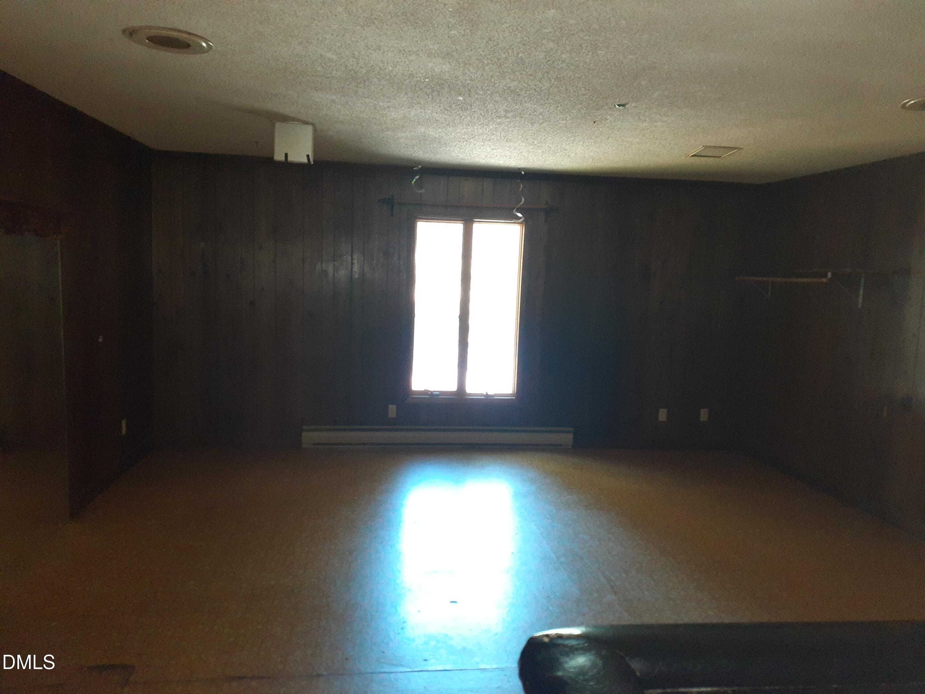 1576 Munns Road Creedmoor, NC 27522 - Photo 19 of 25 a view of empty room with wooden floor and fan