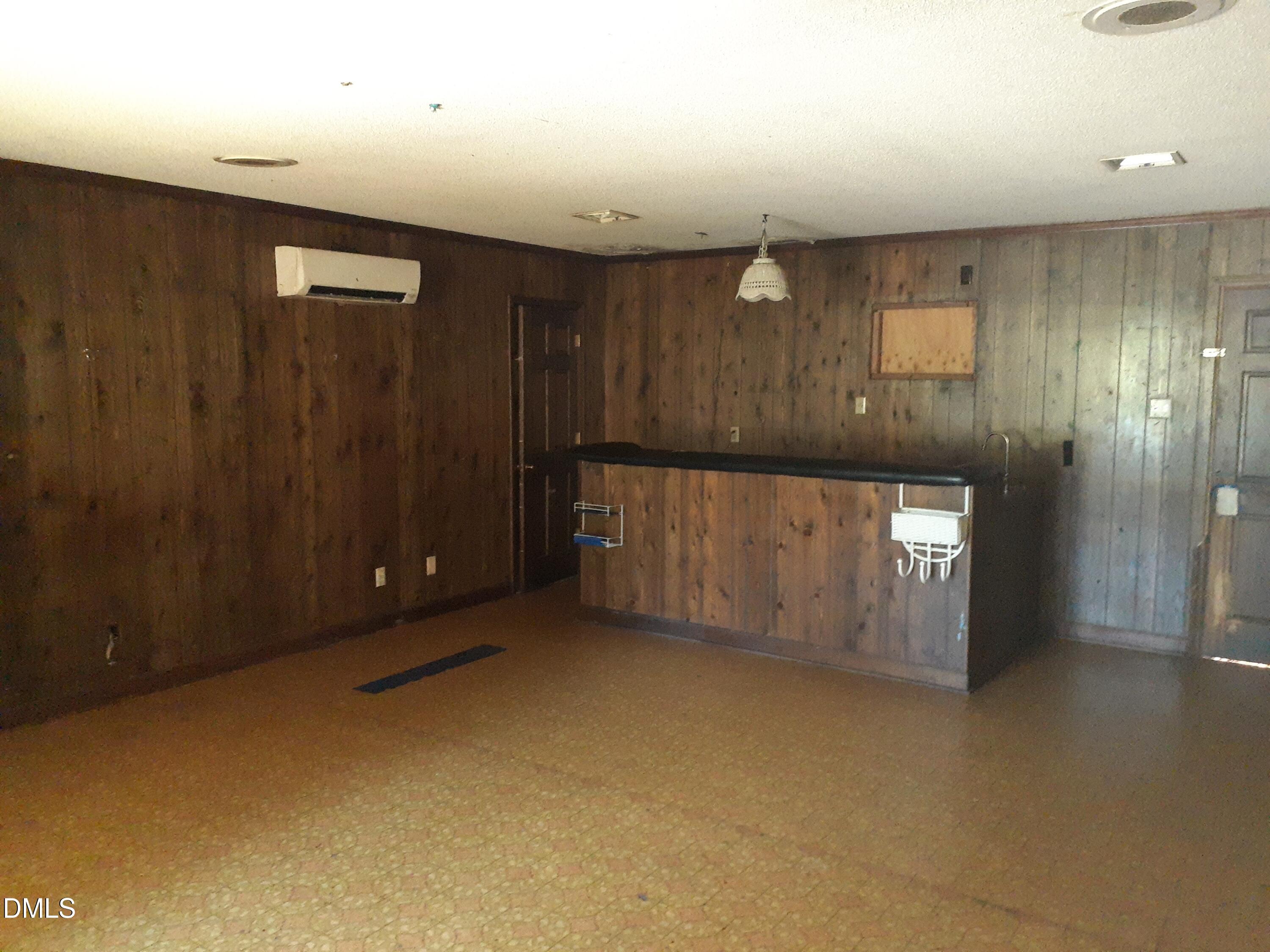 1576 Munns Road Creedmoor, NC 27522 - Photo 20 of 25 an empty room with wooden floor and brick walls