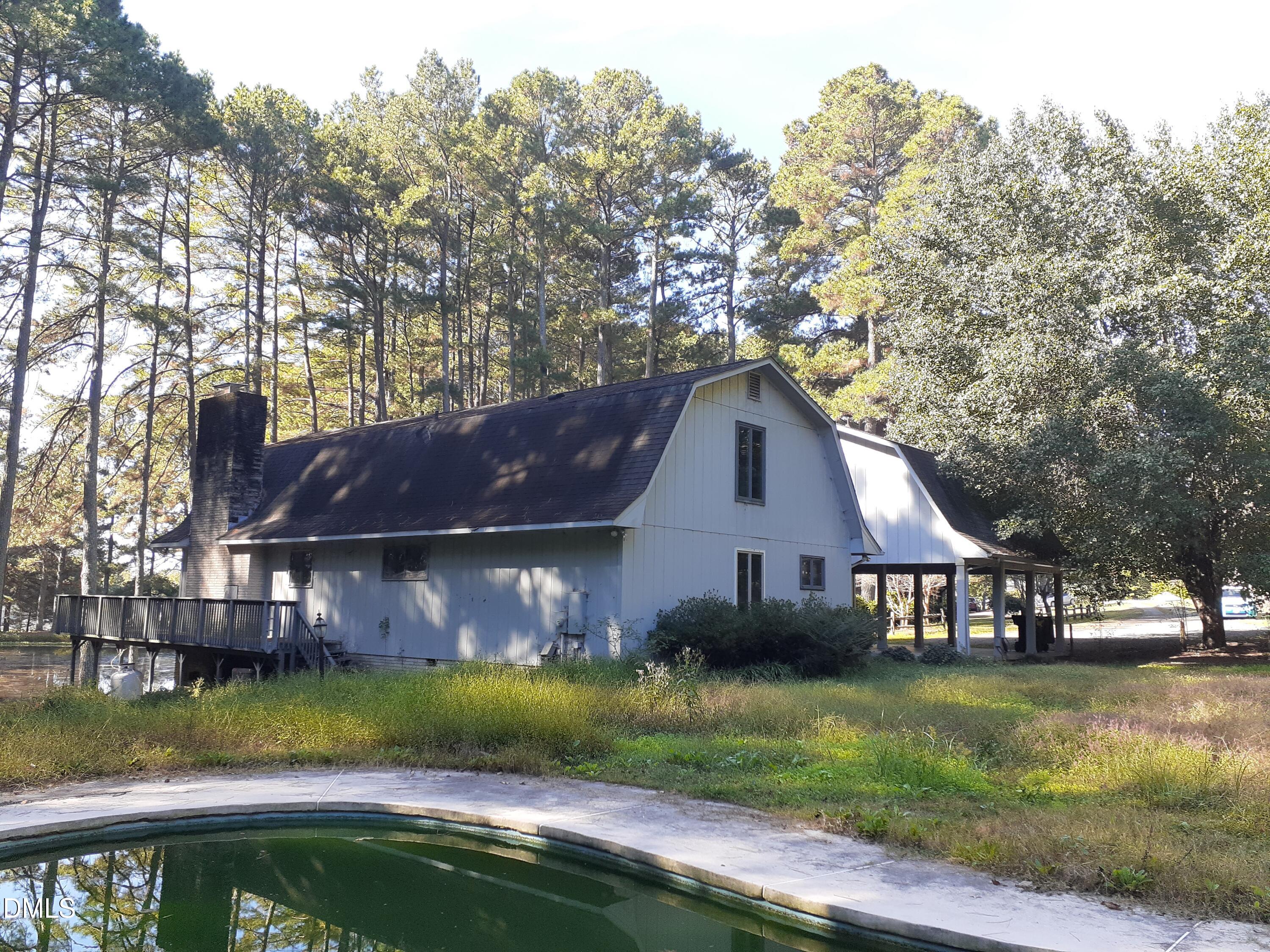 1576 Munns Road Creedmoor, NC 27522 - Photo 2 of 25 a view of house with garden space and swimming pool