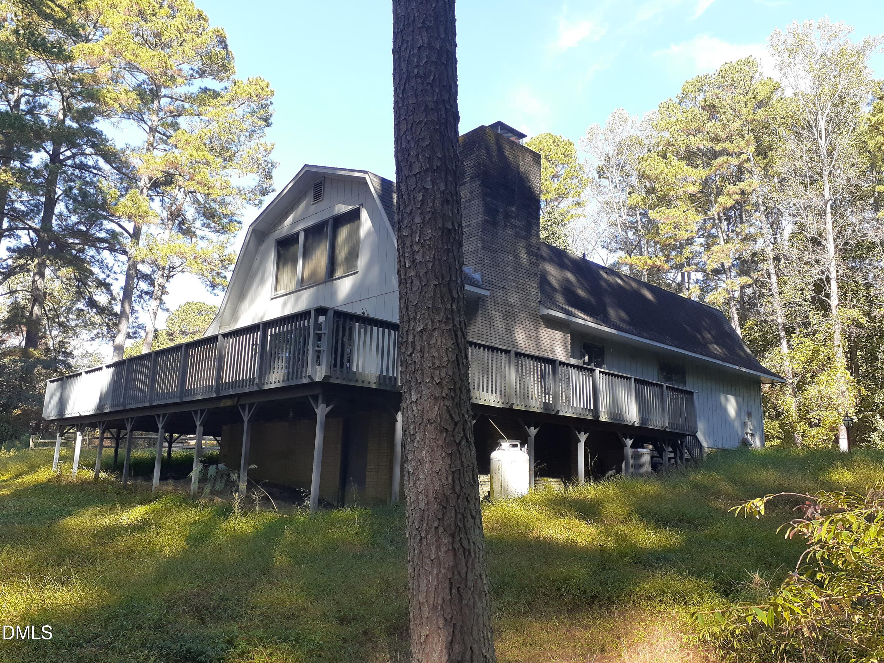 1576 Munns Road Creedmoor, NC 27522 - Photo 5 of 25 a view of a big house with a big yard and large tree