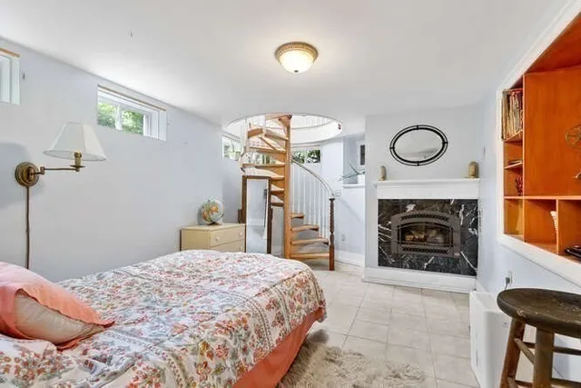 a bedroom with a bed and a fireplace