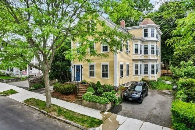 a front view of a house with a garden