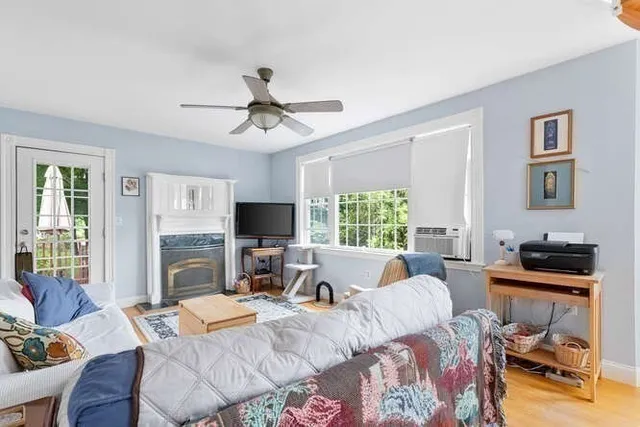 a living room with fireplace furniture and a flat screen tv