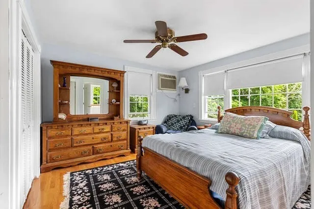 a bedroom with a bed and a large window