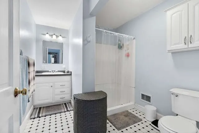 a bathroom with a sink toilet and shower