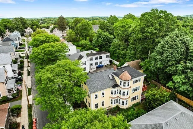 an aerial view of a house with outdoor space and street view