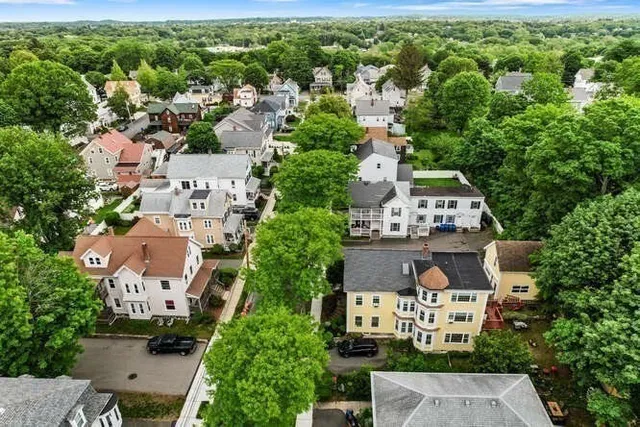 an aerial view of residential houses with outdoor space