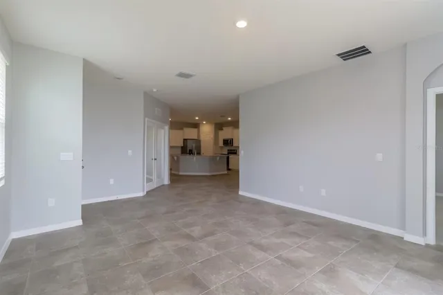 an empty room with a cabinet and mirrors