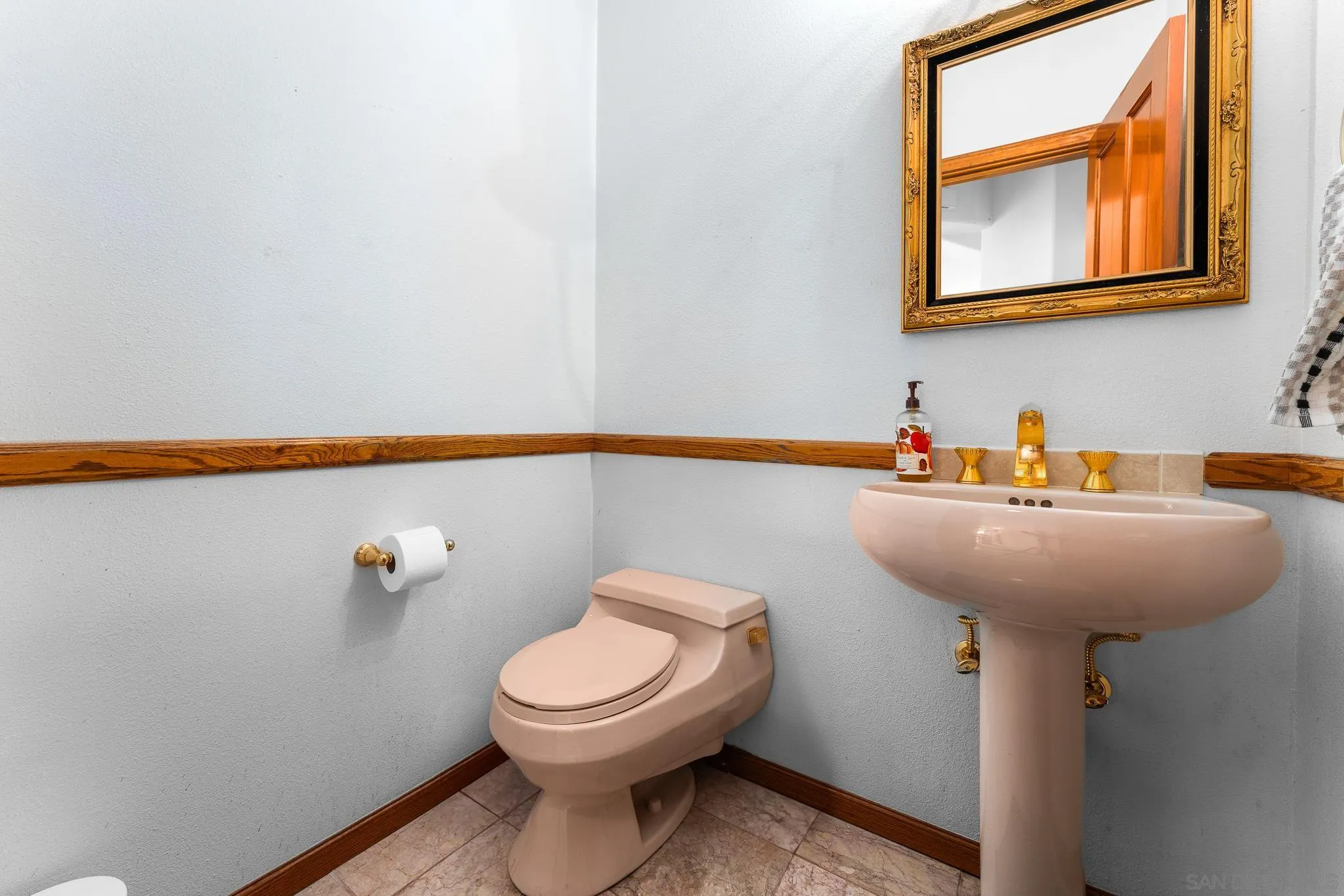 19775 Symeron Road Apple Valley, CA 92307 - Photo 31 of 73 a bathroom with a toilet a sink and mirror