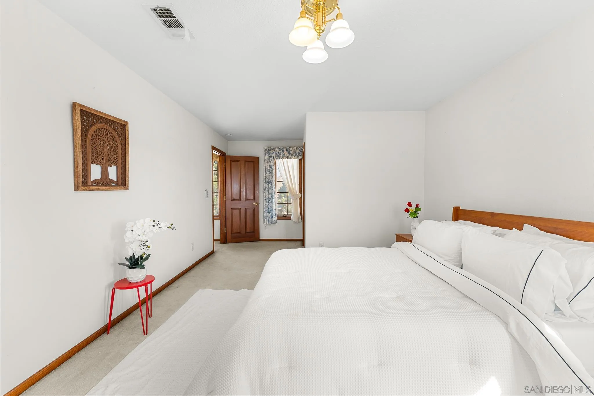 19775 Symeron Road Apple Valley, CA 92307 - Photo 47 of 73 a bedroom with a bed and a chandelier