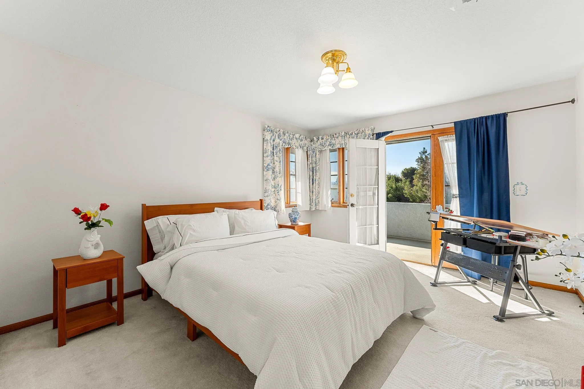 19775 Symeron Road Apple Valley, CA 92307 - Photo 48 of 73 a bedroom with a bed and a chandelier