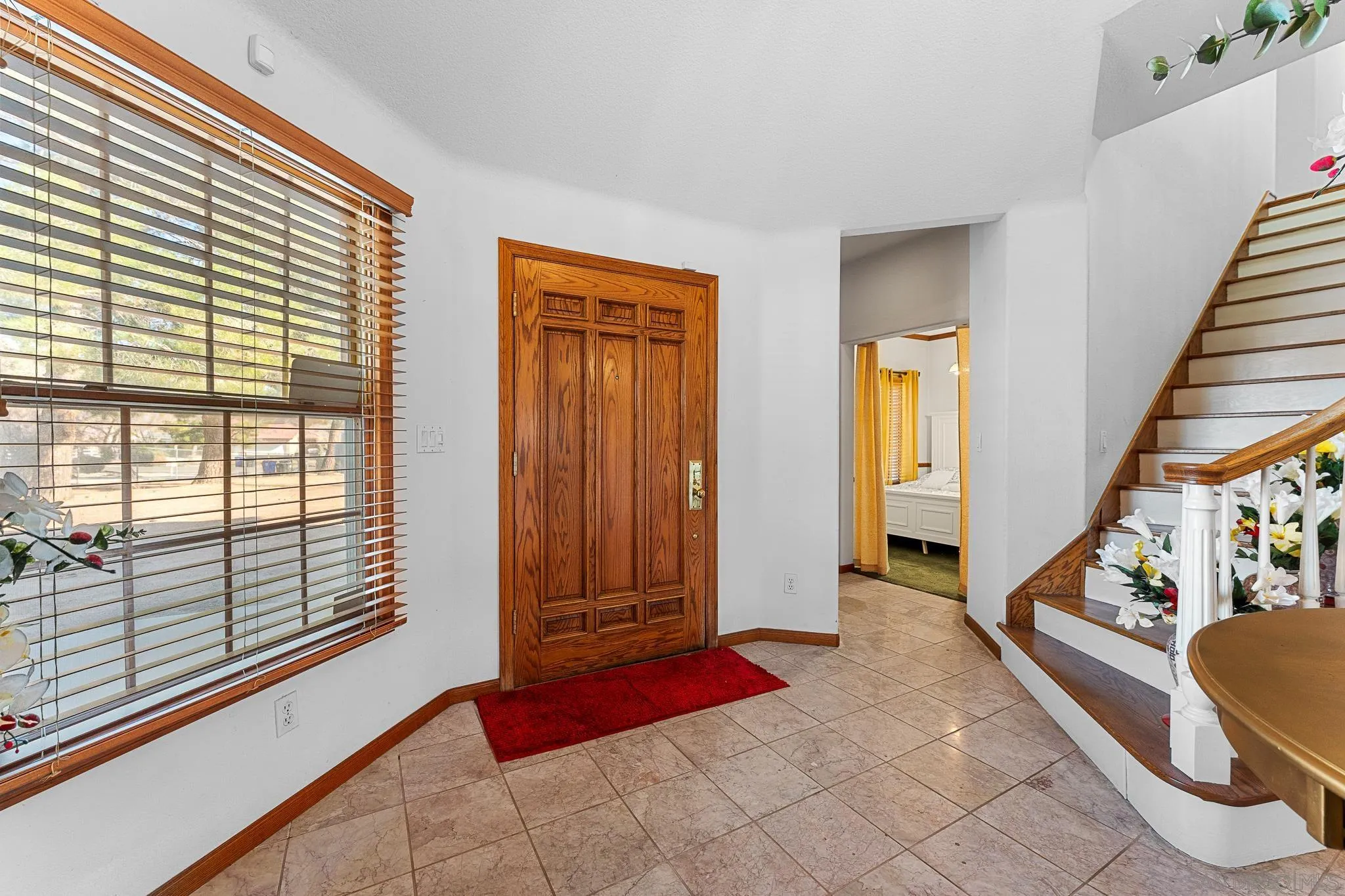 19775 Symeron Road Apple Valley, CA 92307 - Photo 10 of 73 a view of front door with furniture and a window