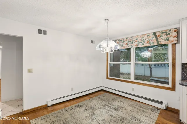 a view of hallway with wooden floor